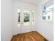Bright entryway with wood floors, a glass front door, and white trim at 1207 Chaney Rd, Raleigh, NC 27606