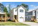 Charming white two-story home with a one-car garage and well-manicured lawn at 1207 Chaney Rd, Raleigh, NC 27606