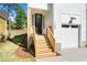 Welcoming front entrance with wooden steps, a glass front door, and exterior lighting at 1207 Chaney Rd, Raleigh, NC 27606
