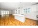 Open concept, eat in kitchen features white cabinets, hardwood floors, an island and stainless steel appliances at 1207 Chaney Rd, Raleigh, NC 27606