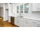 Bright eat in kitchen featuring white cabinets, stainless steel appliances, and a large window at 1207 Chaney Rd, Raleigh, NC 27606
