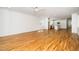 Spacious open-concept living room with hardwood floors and adjacent kitchen at 1207 Chaney Rd, Raleigh, NC 27606