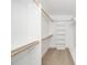 White walk-in closet features shelving, hanging rods and neutral carpet at 1207 Chaney Rd, Raleigh, NC 27606