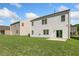 A lush green backyard with a new white siding house at 125 Pisgah St, Sanford, NC 27330