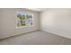 A simple bedroom is brightened by a large window at 125 Pisgah St, Sanford, NC 27330
