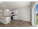 Open-concept kitchen with granite countertops, stainless appliances, and a sliding glass door at 125 Pisgah St, Sanford, NC 27330