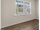 A bright and airy room with neutral walls, wood-look floors, and neighborhood views at 125 Pisgah St, Sanford, NC 27330