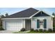 Charming single-Gathering home showcasing a two-car garage, classic shutters, and a well-maintained lawn at 130 Chestnut Oak Ln, Lillington, NC 27546