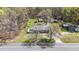 Bird's eye view showcases the house's setting amidst trees, a road, and various outbuildings at 13832 Nc 96 N Hwy, Zebulon, NC 27597