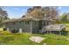The backyard of the home shows a small deck with stairs, a brick exterior, a chain link fence, and a grassy lawn at 13832 Nc 96 N Hwy, Zebulon, NC 27597