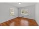 Bedroom with hardwood floors and two windows, creating a bright and airy atmosphere at 13832 Nc 96 N Hwy, Zebulon, NC 27597