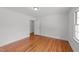 Bedroom with hardwood floors and a doorway, bathed in natural light from the window at 13832 Nc 96 N Hwy, Zebulon, NC 27597