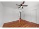 Bedroom with hardwood floors, closet space, a ceiling fan, and a doorway at 13832 Nc 96 N Hwy, Zebulon, NC 27597