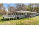 Cozy house with deck and inviting entrance, surrounded by a beautiful lawn at 13832 Nc 96 N Hwy, Zebulon, NC 27597