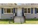 The facade of the house has painted brick and a white front door with blue shutters at 13832 Nc 96 N Hwy, Zebulon, NC 27597