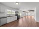 Open concept kitchen with stainless steel appliances, white cabinets, and an attached living area at 13832 Nc 96 N Hwy, Zebulon, NC 27597