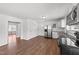 Contemporary kitchen with stainless appliances, open layout, and view into living spaces at 13832 Nc 96 N Hwy, Zebulon, NC 27597