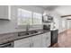 Bright kitchen featuring white cabinets, stainless steel appliances, granite countertops, and a double basin sink at 13832 Nc 96 N Hwy, Zebulon, NC 27597