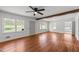 Spacious room showcasing large windows, hardwood floors, and neutral tones for flexible design options at 13832 Nc 96 N Hwy, Zebulon, NC 27597