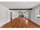 Open living room with hardwood floors, white walls, and seamless flow to other living spaces at 13832 Nc 96 N Hwy, Zebulon, NC 27597