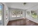 Bright room featuring wood floors, a light fixture, and expansive windows leading to an outdoor deck at 13832 Nc 96 N Hwy, Zebulon, NC 27597