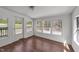 Bright room featuring wood floors, a light fixture, and expansive windows leading to an outdoor deck at 13832 Nc 96 N Hwy, Zebulon, NC 27597
