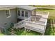 Backyard deck featuring stairs, wood railing, and access to the sunroom, perfect for outdoor relaxation and entertaining at 13832 Nc 96 N Hwy, Zebulon, NC 27597