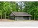 Exterior of community bath house with three doors and neutral tones, set among the trees at 142 Blackhawk Dr, Louisburg, NC 27549