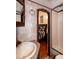 RV bathroom with mirror and cabinet with a view to the main bedroom at 142 Blackhawk Dr, Louisburg, NC 27549