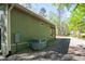 Side of home featuring green siding, gravel landscaping, and an air conditioning unit at 142 Blackhawk Dr, Louisburg, NC 27549