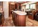 Bright RV kitchen with wood cabinets, breakfast bar and access to the dining and seating areas at 142 Blackhawk Dr, Louisburg, NC 27549