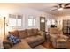 Bright living room features wood floors, ceiling fan, and comfortable seating at 142 Blackhawk Dr, Louisburg, NC 27549