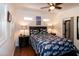 This main bedroom features a patterned quilt, ceiling fan and multiple windows at 142 Blackhawk Dr, Louisburg, NC 27549