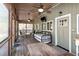 Relaxing screened-in porch with ceiling fans, rocking chairs, a daybed, and outdoor dining area at 142 Blackhawk Dr, Louisburg, NC 27549