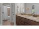 Bathroom with double sink, dark cabinets, and bathtub-shower combo at 1512 Piazzo Ct, Apex, NC 27502