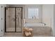 Bathroom featuring walk-in shower, soaking tub, and natural light from the window at 1512 Piazzo Ct, Apex, NC 27502