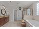Elegant bathroom features a soaking tub, glass shower, and granite countertop vanity at 1512 Piazzo Ct, Apex, NC 27502
