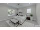 Serene bedroom featuring a queen bed, bench, and bright window at 1512 Piazzo Ct, Apex, NC 27502