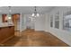 Open dining area with wood floors, large windows, and views of the kitchen at 1512 Piazzo Ct, Apex, NC 27502