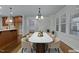 Staged dining room with a table, seating for six, and a view of the kitchen at 1512 Piazzo Ct, Apex, NC 27502
