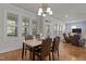A dining room with hardwood floors, plantation shutters and views into the living room at 1512 Piazzo Ct, Apex, NC 27502