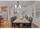 A dining room featuring hardwood floors, a decorative chandelier and four leather chairs at 1512 Piazzo Ct, Apex, NC 27502