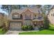 Charming brick home with a two-car garage and beautifully landscaped front yard at 1512 Piazzo Ct, Apex, NC 27502