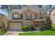 Beautiful brick home with a manicured lawn, attached garage, and covered front porch at 1512 Piazzo Ct, Apex, NC 27502