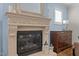 Detailed fireplace with a decorative mantel, a modern fireplace insert and wood accents at 1512 Piazzo Ct, Apex, NC 27502