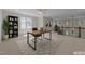 Bright home office space featuring a modern desk, stylish rug, and staircase with natural light at 1512 Piazzo Ct, Apex, NC 27502
