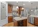 A well-equipped kitchen with stainless appliances, granite counters, and a wine rack in the island at 1512 Piazzo Ct, Apex, NC 27502