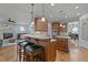 Spacious kitchen featuring wood cabinets, granite counters, stainless appliances, and island with seating at 1512 Piazzo Ct, Apex, NC 27502