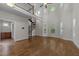 Bright living room with hardwood floors, tall ceilings, and a spiral staircase leading to the second floor at 1512 Piazzo Ct, Apex, NC 27502