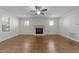 Bright living room with hardwood floors, fireplace and ceiling fan at 1512 Piazzo Ct, Apex, NC 27502